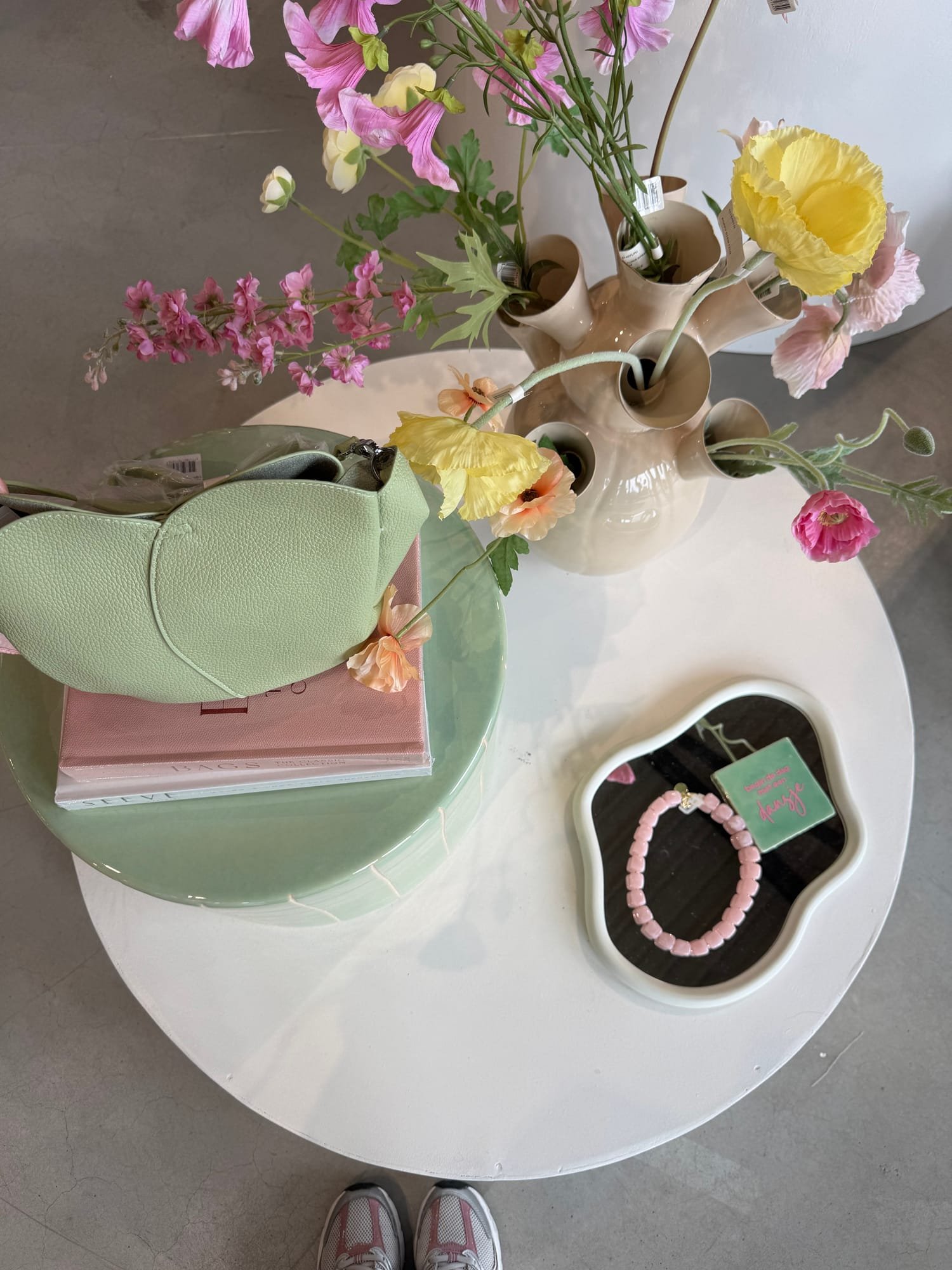 Mintgrüne Ledertasche, Schmuck und Accessoires auf einem Kamé Display